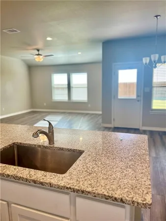 a bathroom with a granite countertop sink a mirror and window