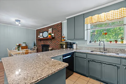 a kitchen with a sink cabinets and a wooden floor