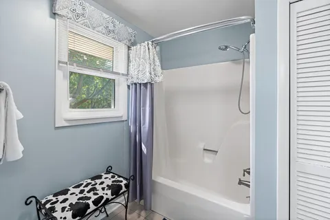 a bathroom with a bathtub and shower