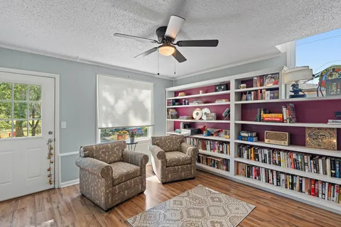 a living room with furniture and a book shelf