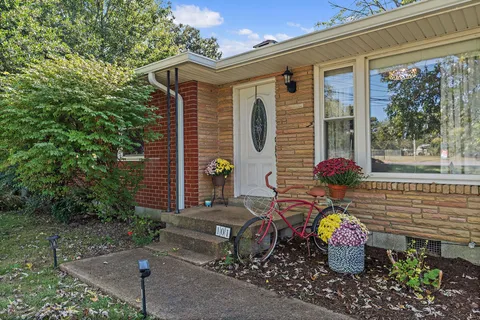 a front view of a house with outdoor seating