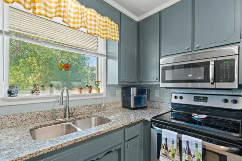 a kitchen with a stove and a sink