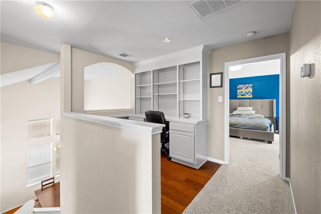 3508 Bratton Ridge Crossing Austin, TX 78728 - Photo 13 of 18 A versatile upstairs loft with built-in desk and shelving provides an ideal work-from-home space.