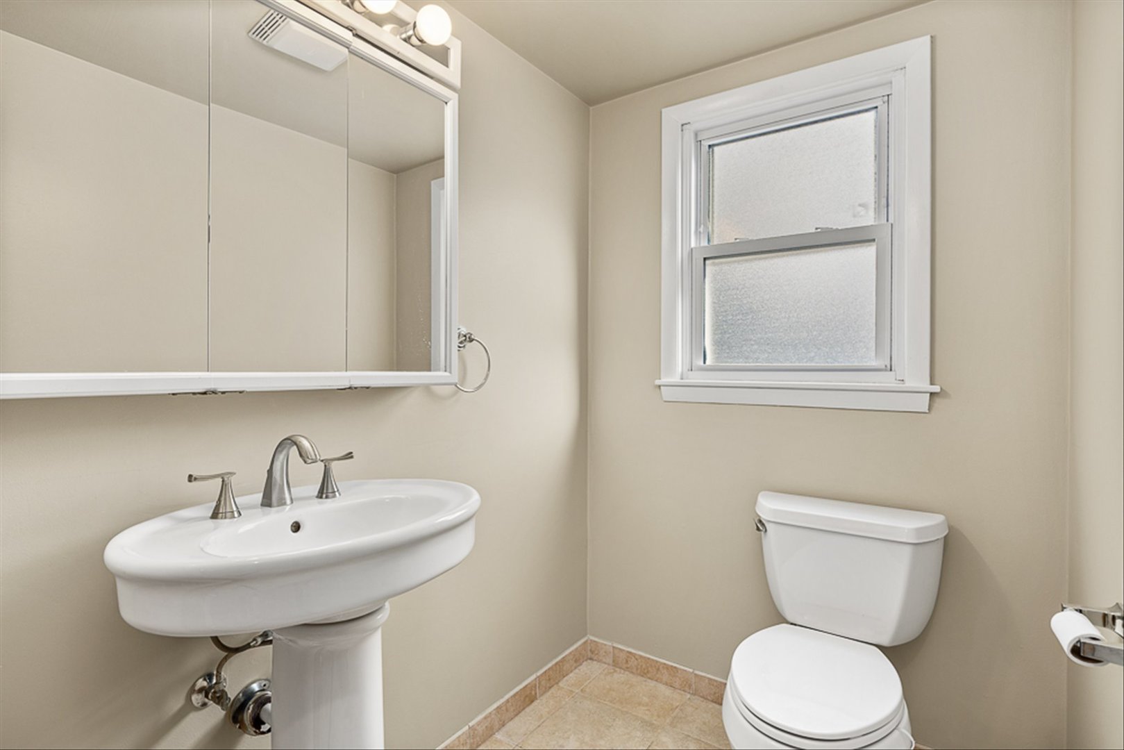 5631 South Oak Street Hinsdale, IL 60521 - Photo 13 of 38 a bathroom with a toilet sink and mirror