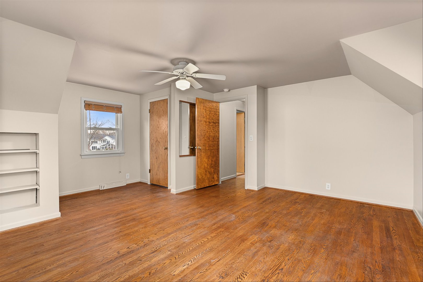 5631 South Oak Street Hinsdale, IL 60521 - Photo 17 of 38 an empty room with wooden floor chandelier fan and windows