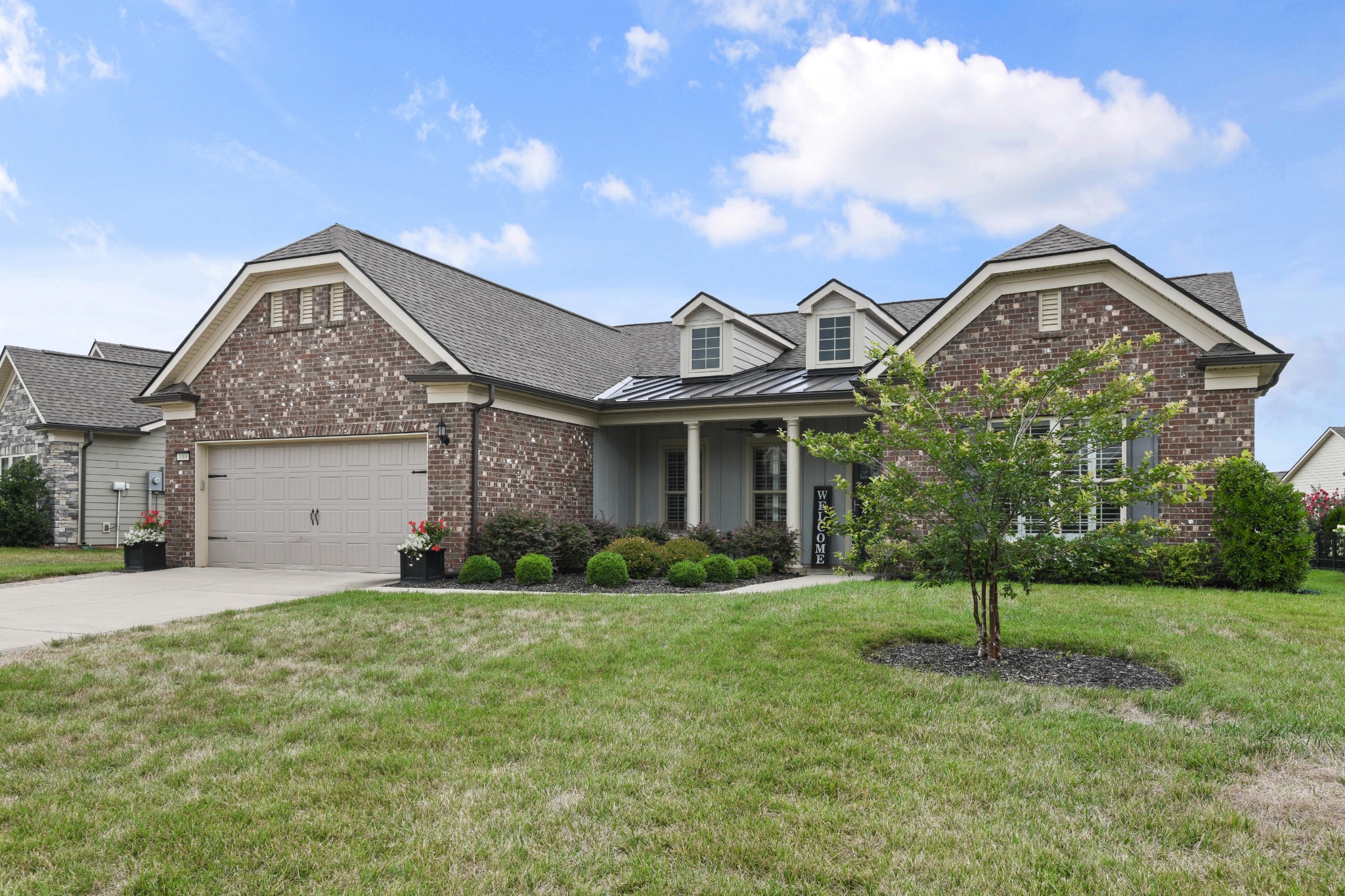 1009 Coffee Ridge Spring Hill, TN 37174 - Photo 3 of 53 a front view of a house with a yard
