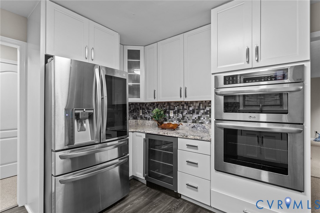 10710 Courthouse Road Dinwiddie, VA 23841 - Photo 11 of 48 a kitchen with stainless steel appliances white cabinets and a refrigerator