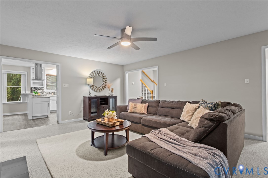 10710 Courthouse Road Dinwiddie, VA 23841 - Photo 14 of 48 a living room with furniture a fireplace and a chandelier