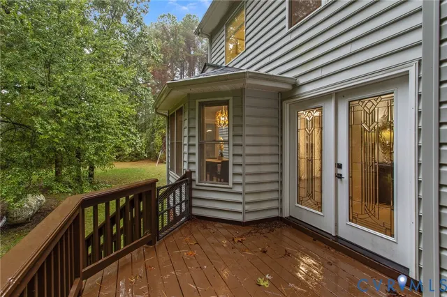 a view of a house with backyard and deck
