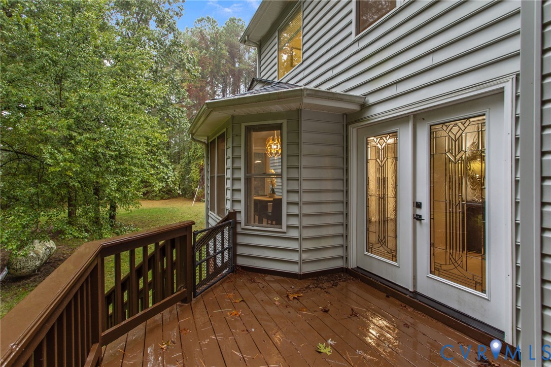 10710 Courthouse Road Dinwiddie, VA 23841 - Photo 17 of 48 a view of a house with backyard and deck
