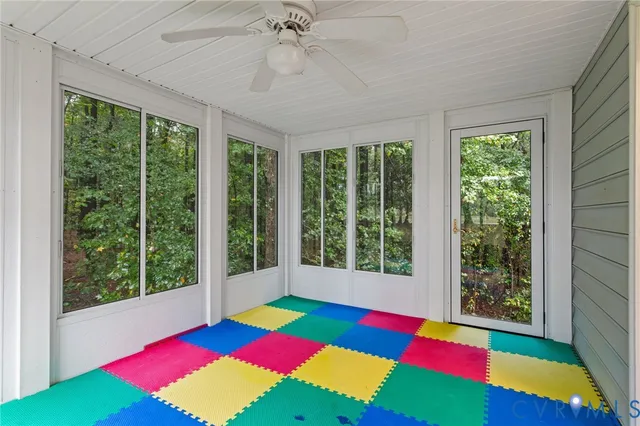 a room with pool table and windows
