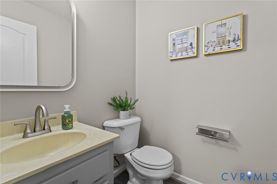 10710 Courthouse Road Dinwiddie, VA 23841 - Photo 20 of 48 a bathroom with a toilet a sink and mirror