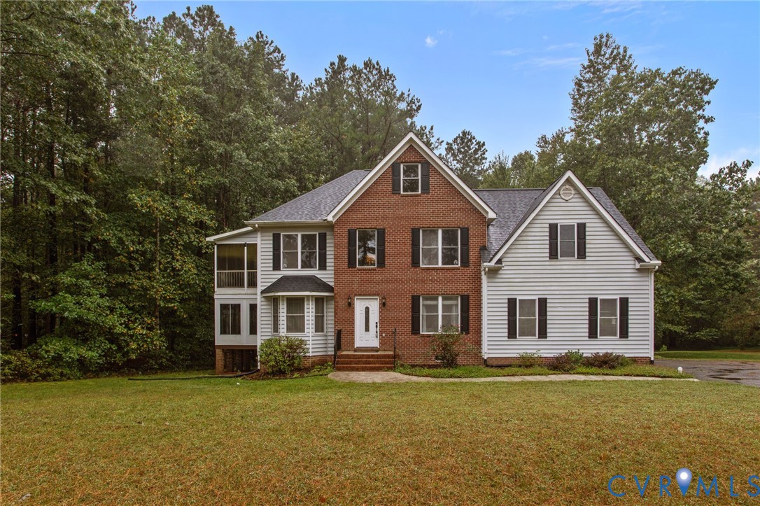 10710 Courthouse Road Dinwiddie, VA 23841 - Photo 2 of 48 a front view of a house with a garden