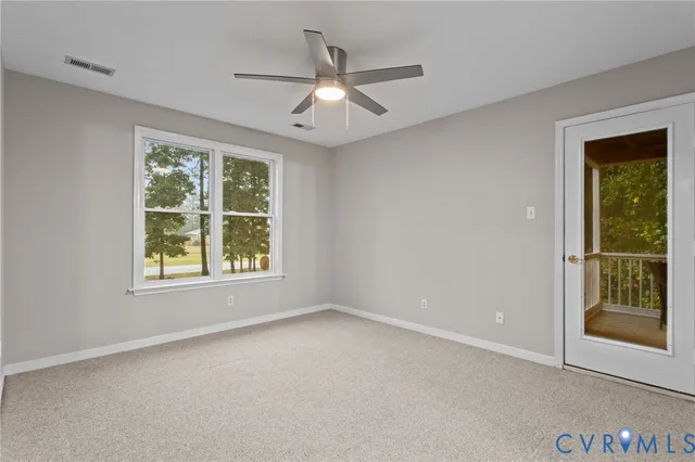 an empty room with closet and a hallway