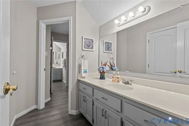 a bathroom with a granite countertop toilet sink and shower