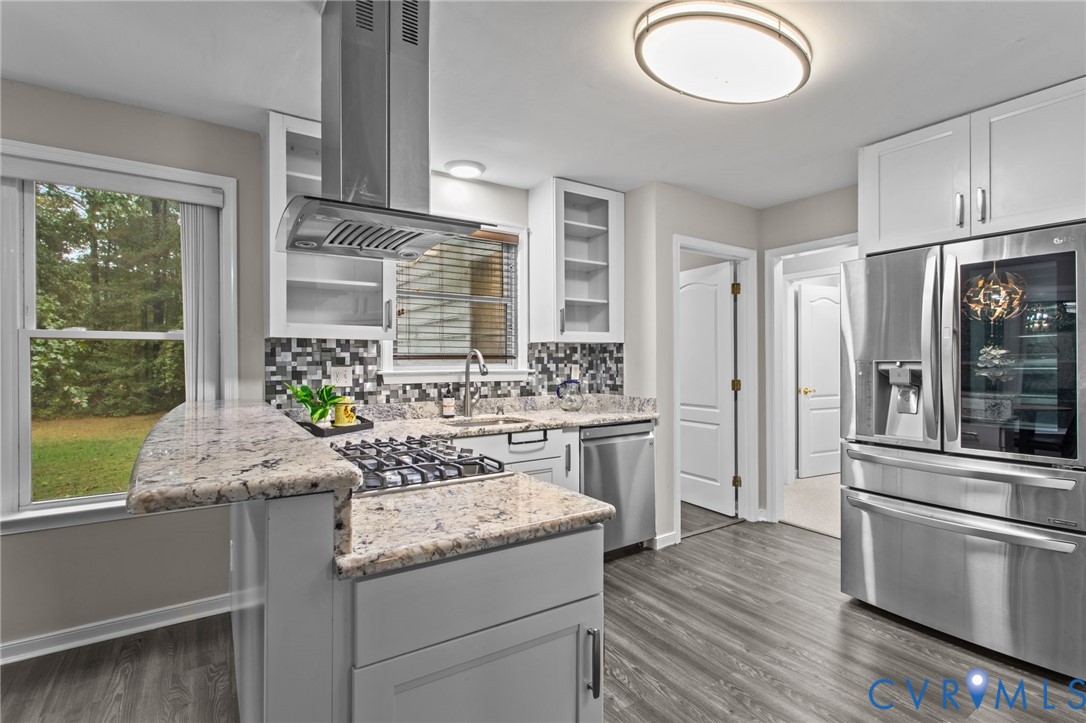 10710 Courthouse Road Dinwiddie, VA 23841 - Photo 9 of 48 a kitchen with granite countertop a stove a sink and a refrigerator