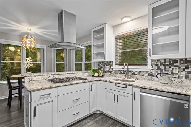 a kitchen with stainless steel appliances granite countertop white cabinets and a granite counter tops