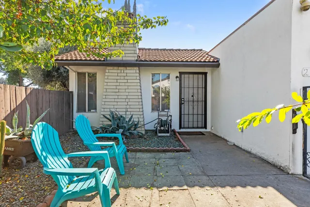 a backyard of a house with table and chairs