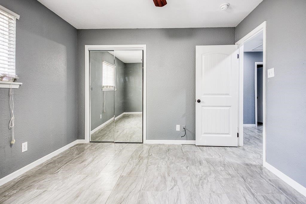 1810 Marlin Street Portland, TX 78374 - Photo 21 of 32 an empty room with wooden floor and windows