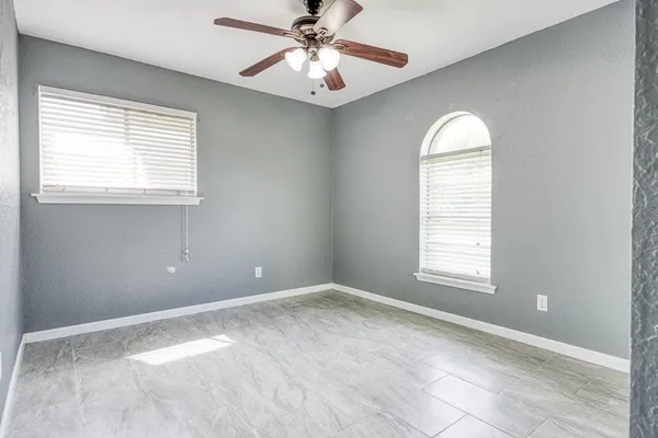 an empty room with windows and closet