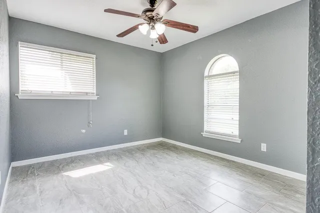 an empty room with windows and closet