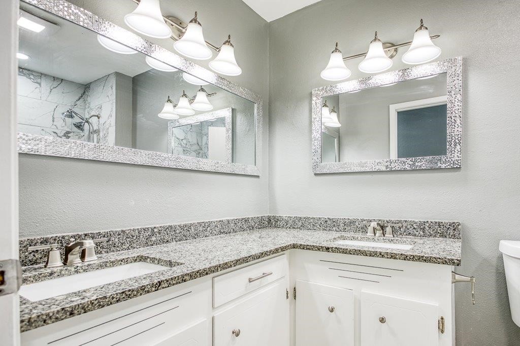 1810 Marlin Street Portland, TX 78374 - Photo 24 of 32 a bathroom with a sink a mirror and a chandelier