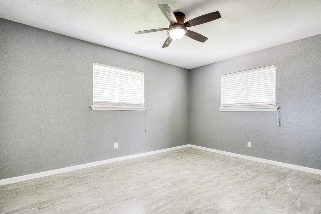 1810 Marlin Street Portland, TX 78374 - Photo 26 of 32 an empty room with a window and a fan