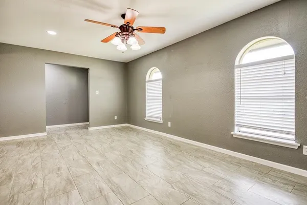 a view of a kitchen with a sink and a chandelier fan