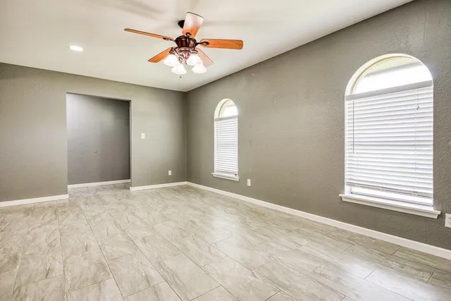 a view of a kitchen with a sink and a chandelier fan