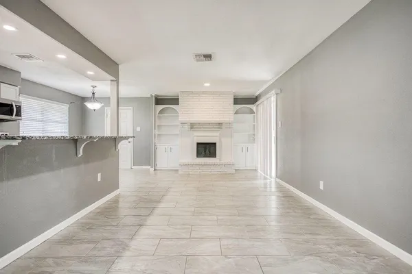 a view of a livingroom with a fireplace and cabinet