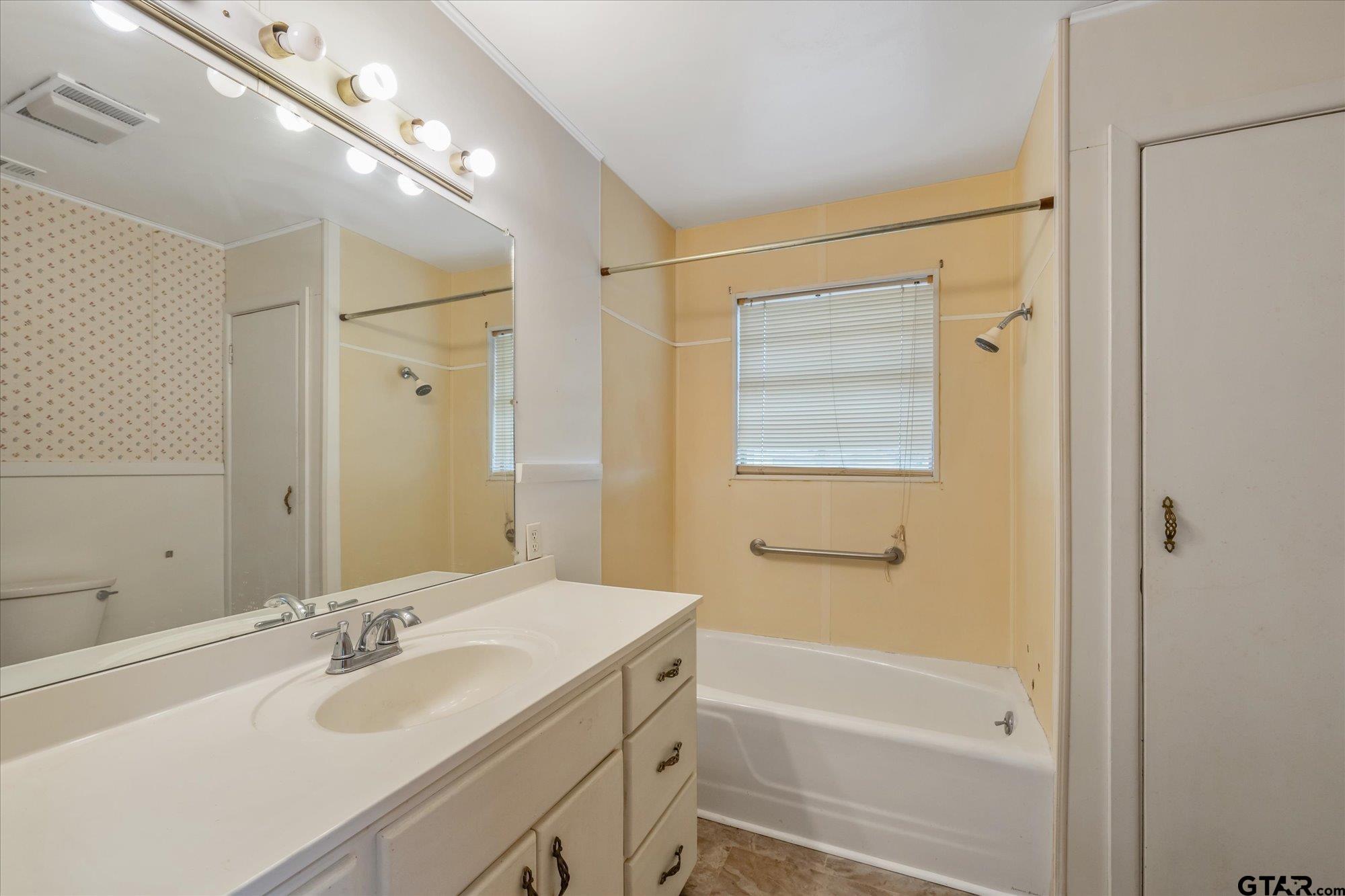 11619 County Road 4331 Larue, TX 75770 - Photo 11 of 30 a bathroom with a tub sink and mirror