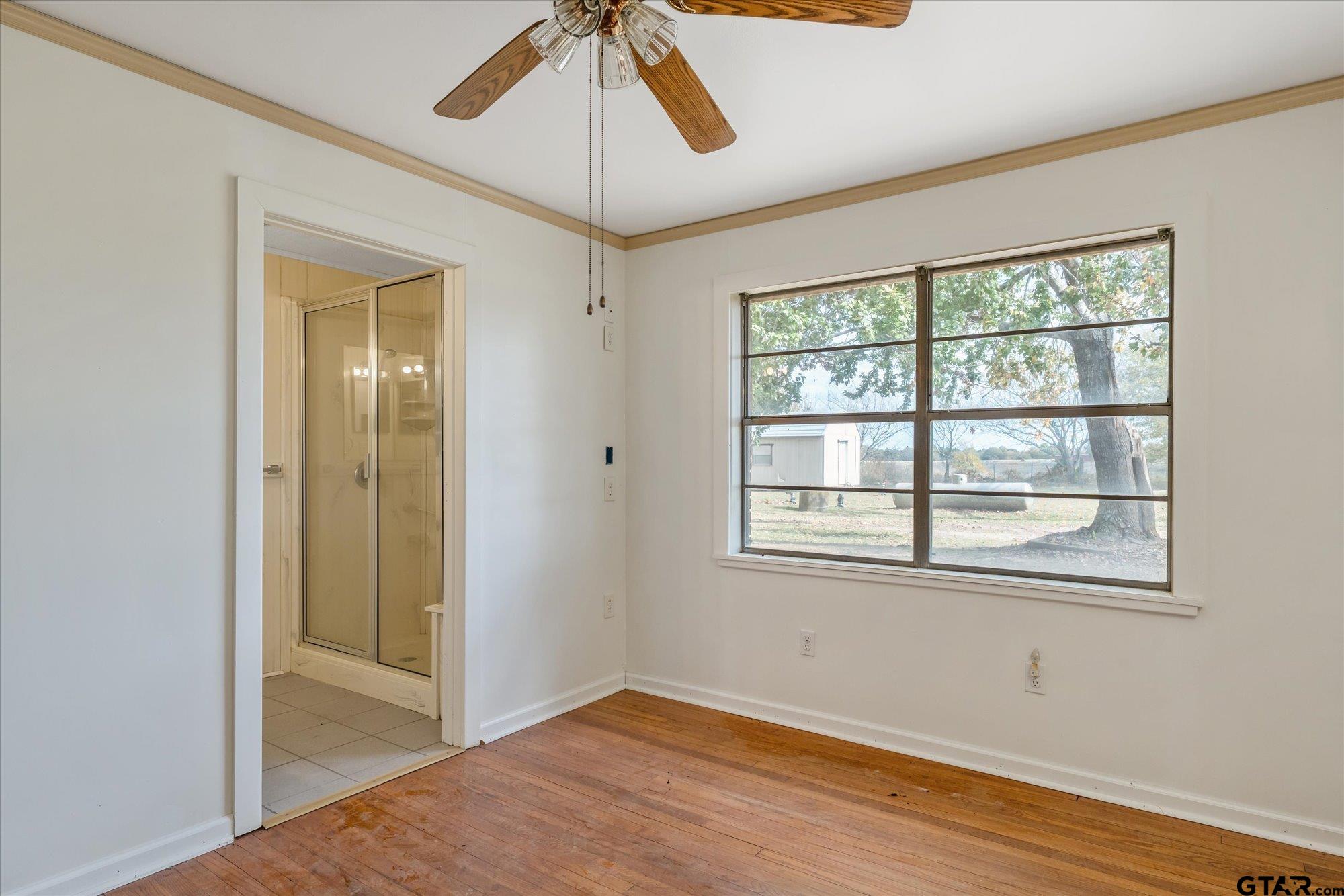 11619 County Road 4331 Larue, TX 75770 - Photo 12 of 30 a view of an empty room with a window and wooden floor
