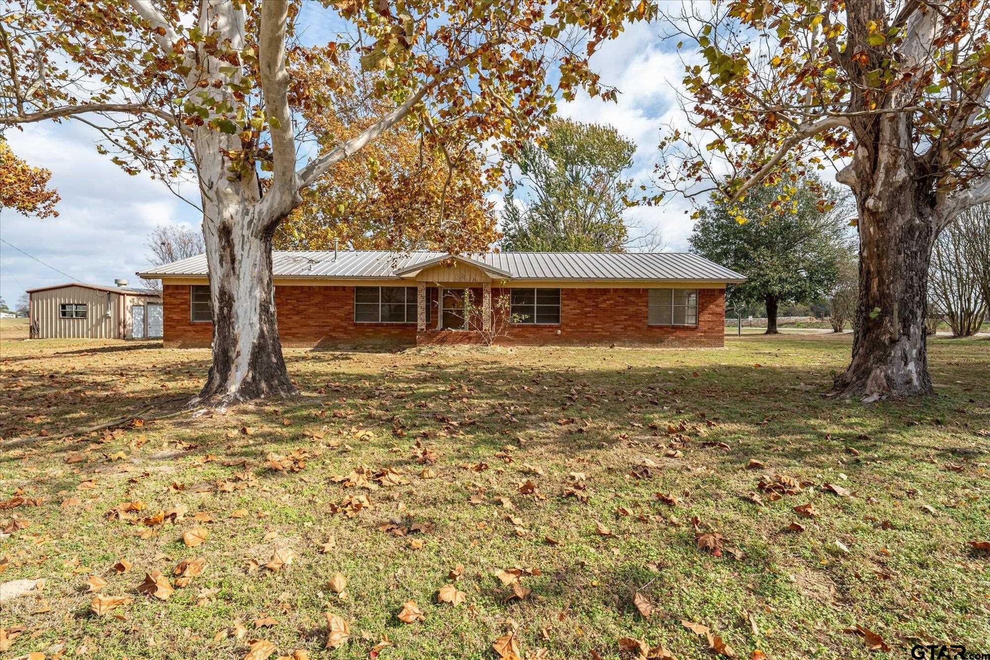 11619 County Road 4331 Larue, TX 75770 - Photo 26 of 30 a view of a large pool with lawn chairs under an large trees