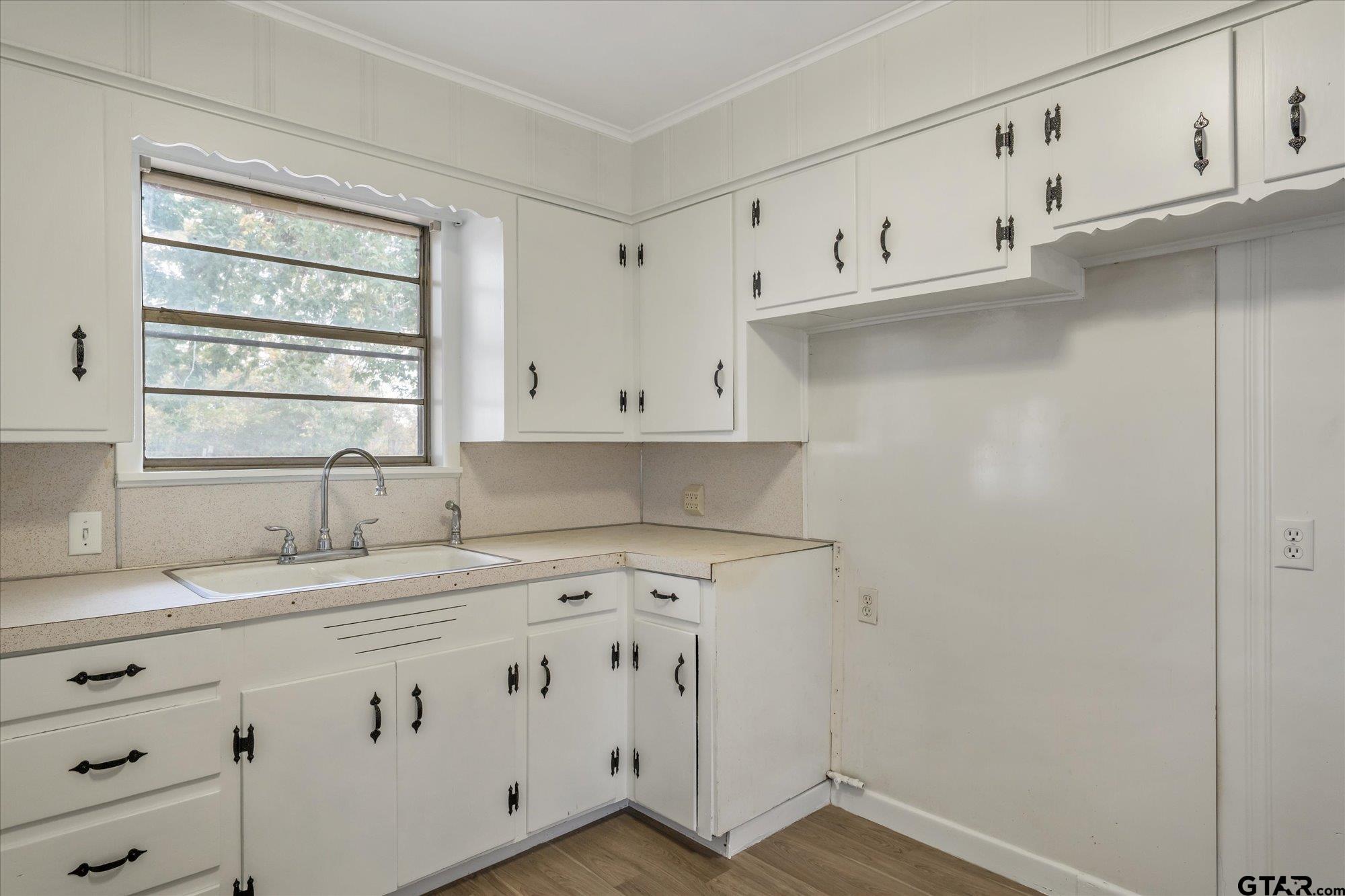 11619 County Road 4331 Larue, TX 75770 - Photo 6 of 30 a kitchen with cabinets appliances a sink and a window