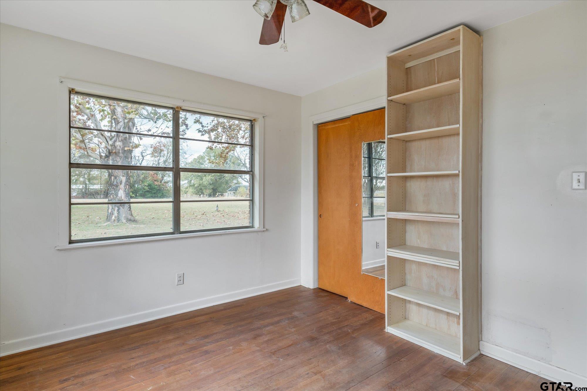 11619 County Road 4331 Larue, TX 75770 - Photo 10 of 30 a view of an empty room with a window and wooden floor