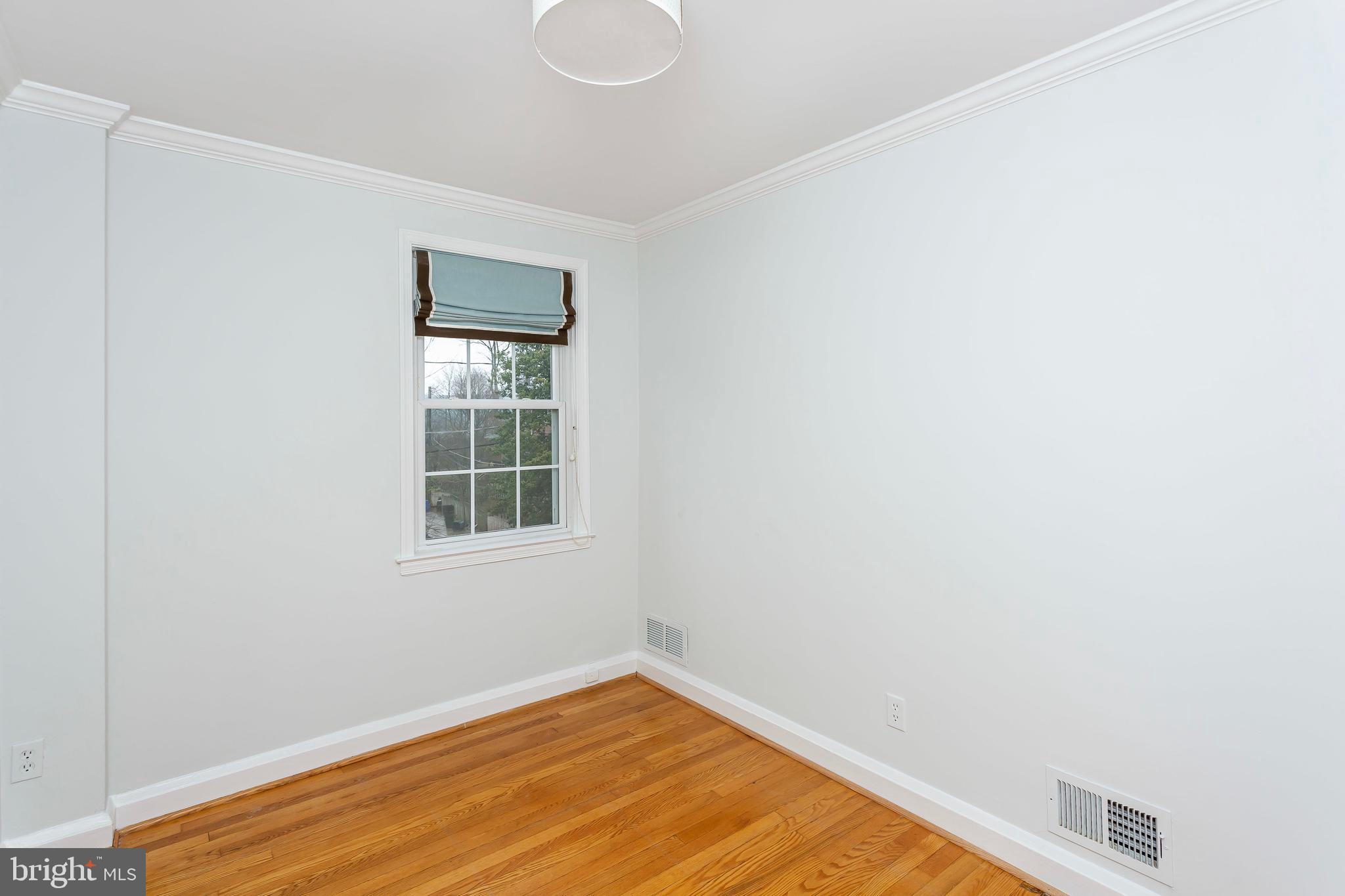 236 Stanmore Road Baltimore, MD 21212 - Photo 27 of 51 a view of an empty room with wooden floor and a window