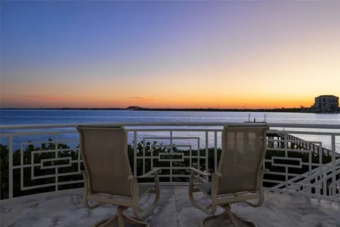 a view of a house with pool and sitting area