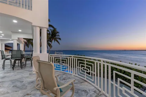 a living room with furniture floor to ceiling window and a floor to ceiling window