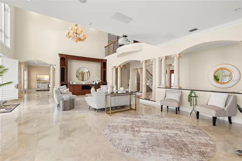 a large white kitchen with a large window
