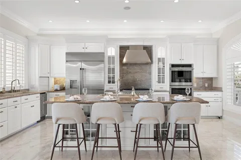 a dining room with furniture and large windows