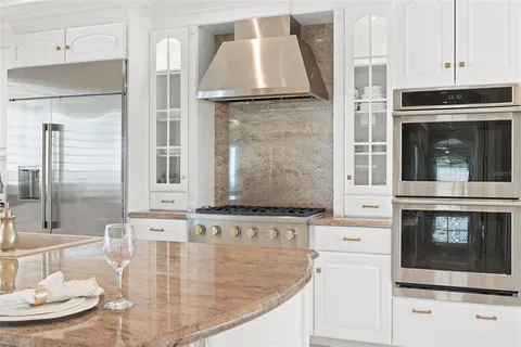 a bathroom with a granite countertop toilet a sink and a mirror