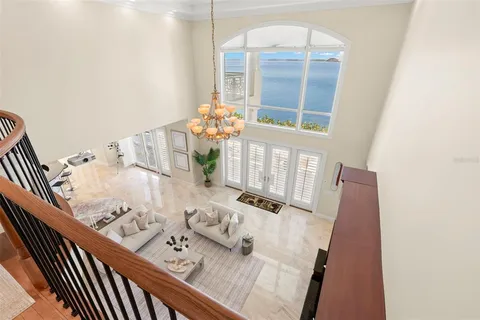 a large white kitchen with a large window