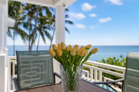 a view of balcony with wooden floor and fence
