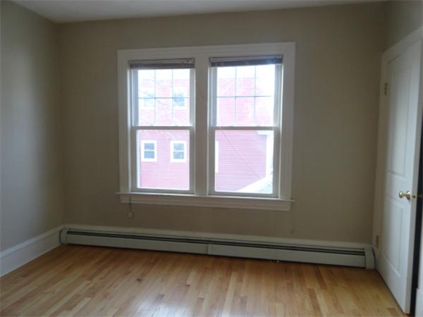 34 Meadow Road, Unit 4 Woonsocket, RI 02895 - Photo 12 of 12 an empty room with wooden floor and windows