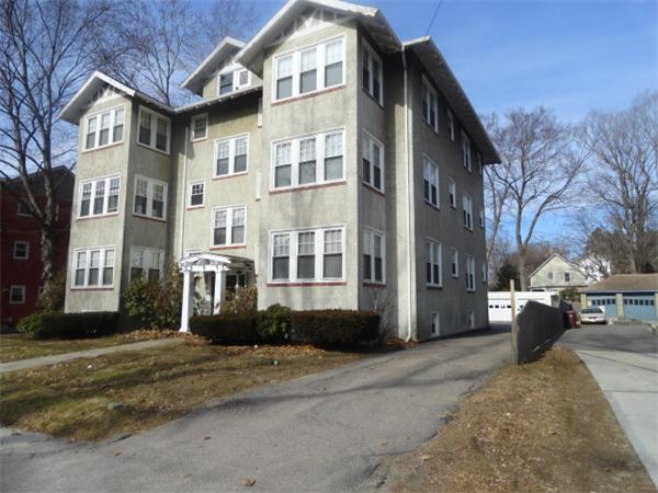 34 Meadow Road, Unit 4 Woonsocket, RI 02895 - Photo 2 of 12 a front view of a building with a yard