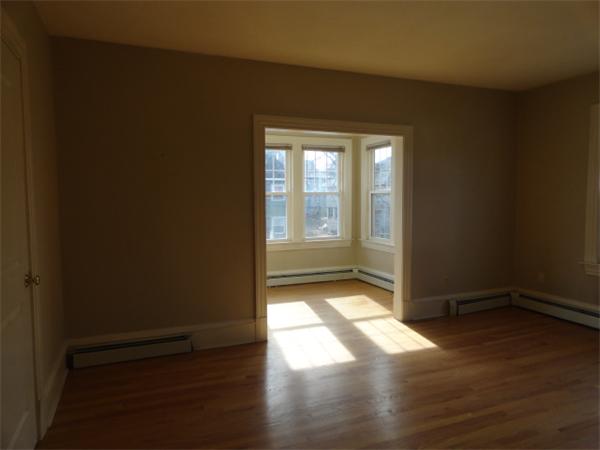 34 Meadow Road, Unit 4 Woonsocket, RI 02895 - Photo 6 of 12 a view of empty room with wooden floor and fan