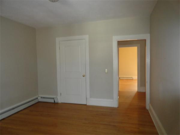 34 Meadow Road, Unit 4 Woonsocket, RI 02895 - Photo 7 of 12 a view of an empty room with wooden floor and a window