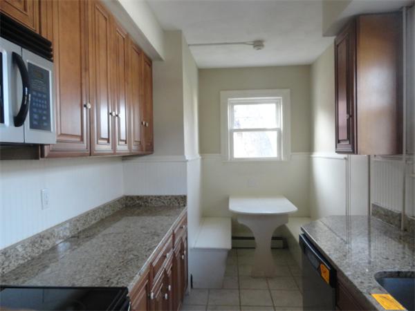 34 Meadow Road, Unit 4 Woonsocket, RI 02895 - Photo 8 of 12 a kitchen with a sink cabinets and chair