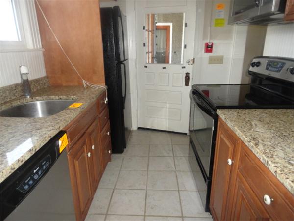 34 Meadow Road, Unit 4 Woonsocket, RI 02895 - Photo 9 of 12 a kitchen with granite countertop a sink stove and refrigerator