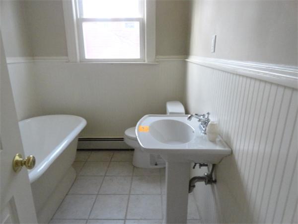 34 Meadow Road, Unit 4 Woonsocket, RI 02895 - Photo 10 of 12 a bathroom with a sink toilet and a mirror